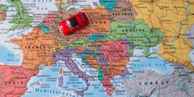 Map of Europe with a red toy car in the middle